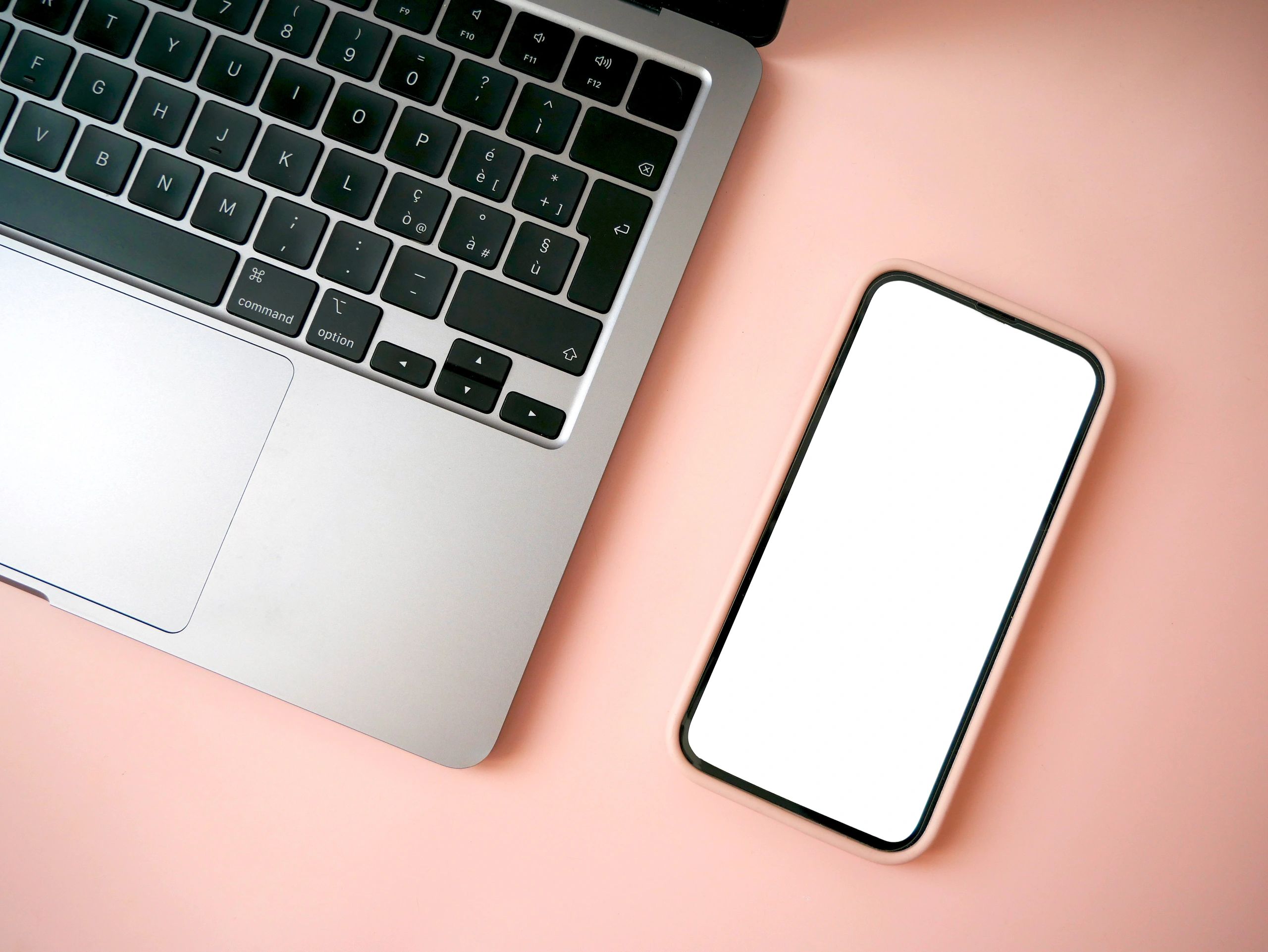 Smartphone and laptop on desk for digital campaign design